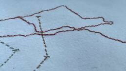 Close-up of stitched lines onto paper
