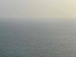 Photograph of sea and sky with blurred horizon line