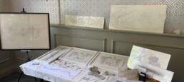 Drawings and mixed materials on table and easel