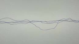 Pen lines wobble horizontally across paper